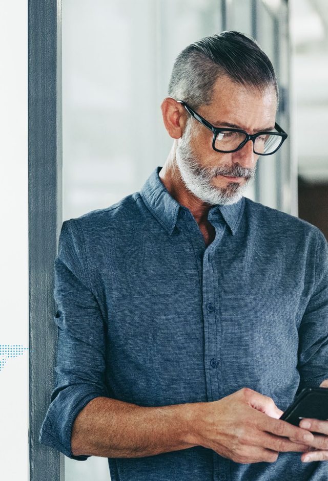 A technology leader reviewing options on a mobile device